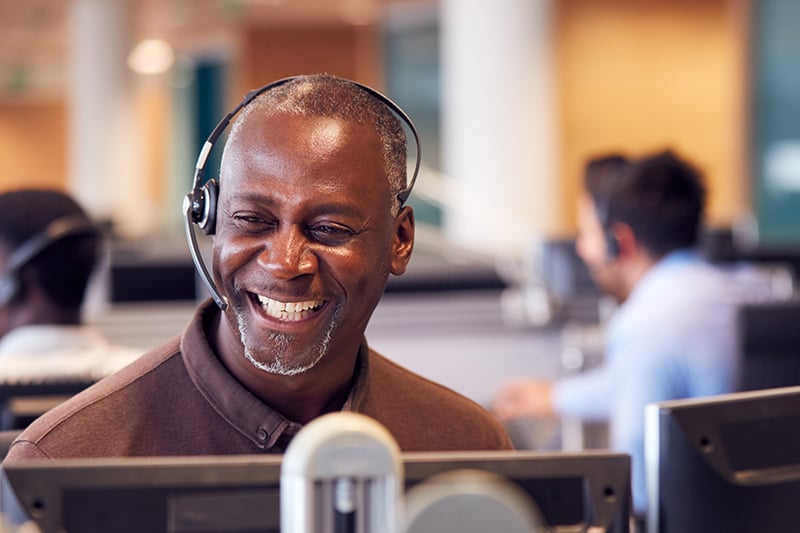 Smiling customer support agent with headset.